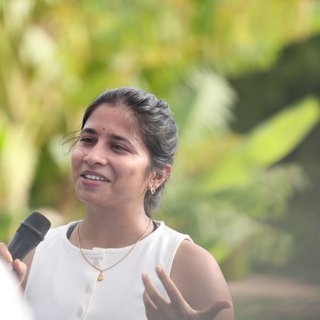 Chitrika speaking to a group during a corporate session