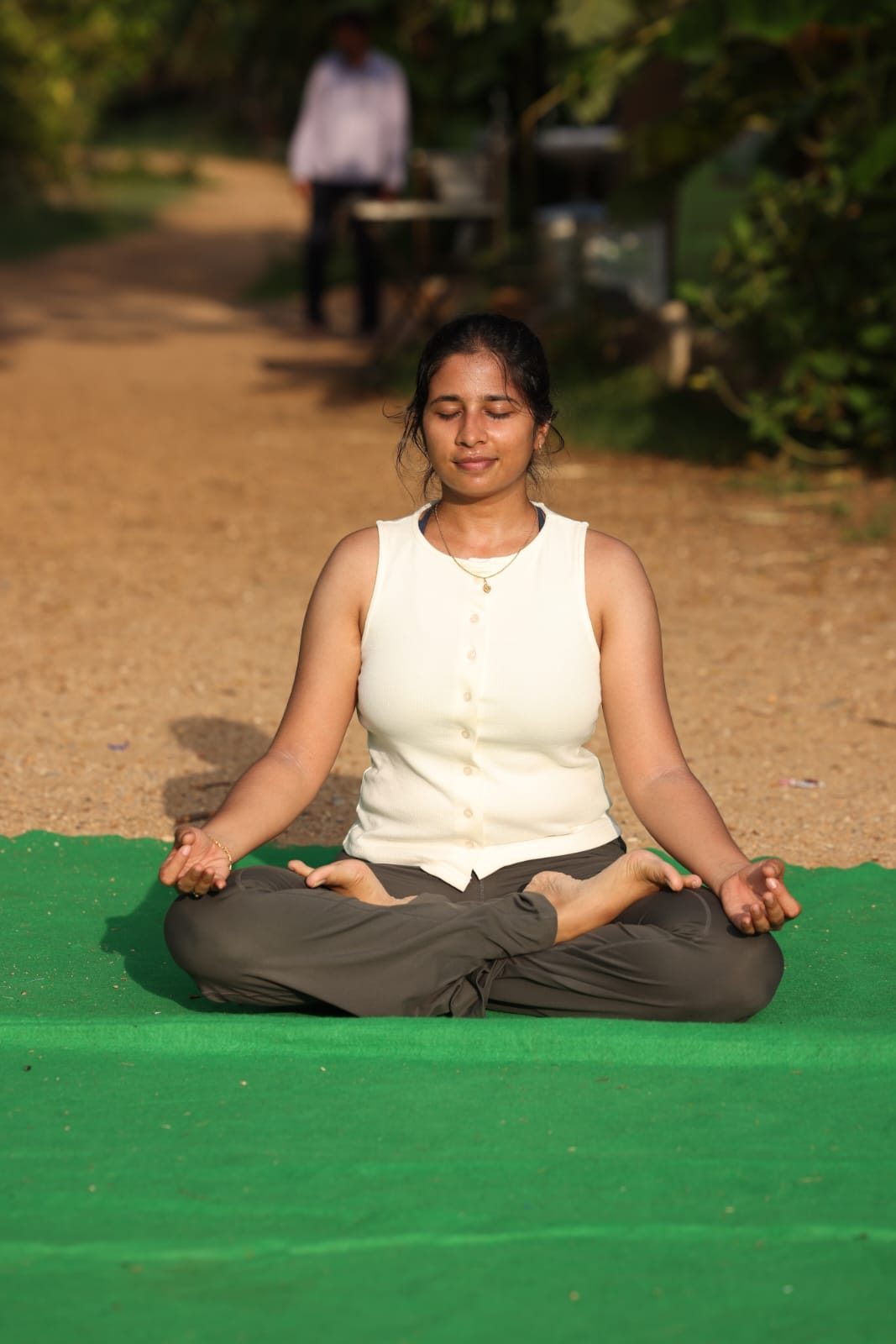 Chitrika seated in meditation outdoors